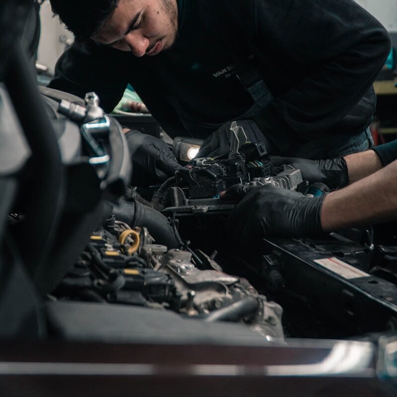 man in black jacket and blue denim jeans riding motorcycle